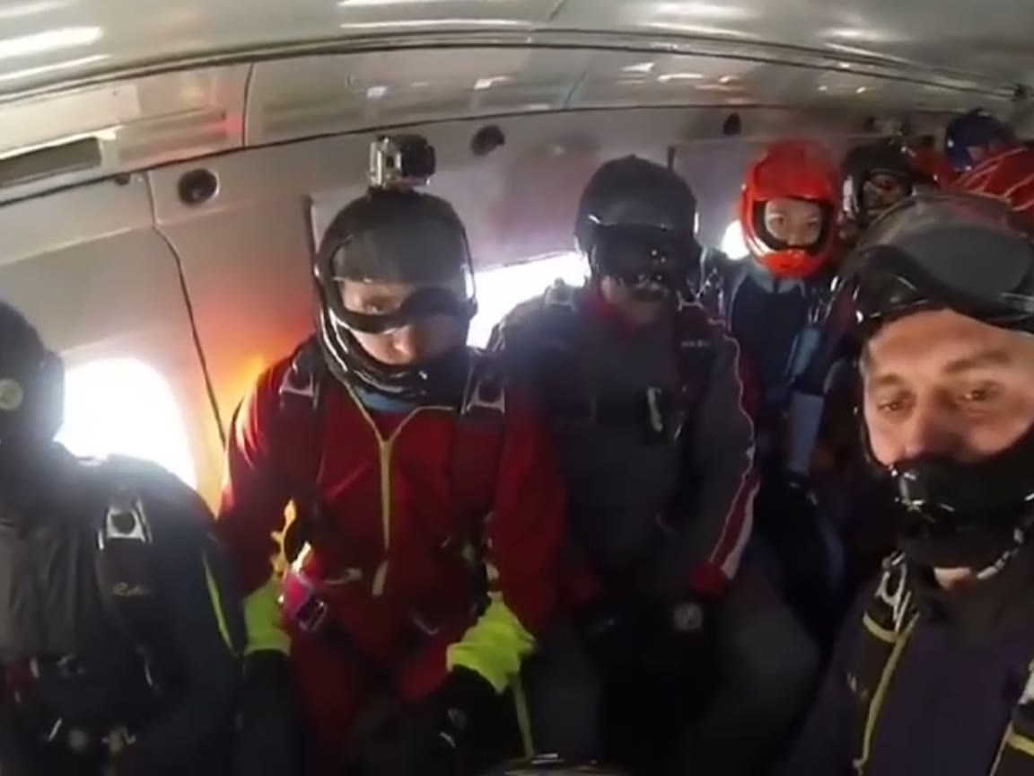 Skydivers in a cabin waiting at the open door